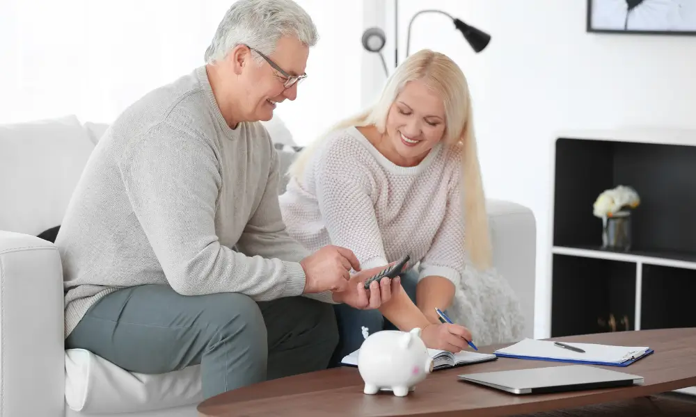 Couple sitting at a coffee table working out their pensions.